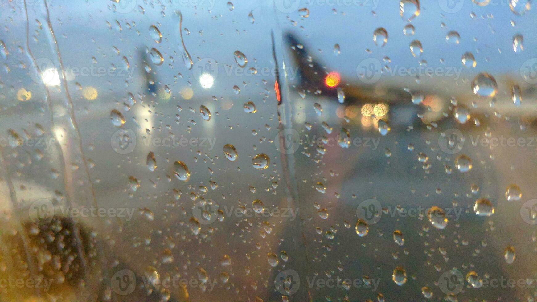 Rainy airplane field through the airplane window photo