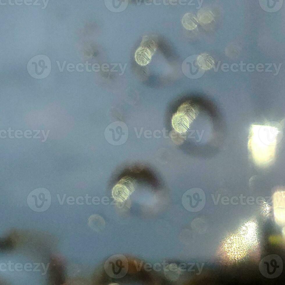Blurred water drops on a window photo