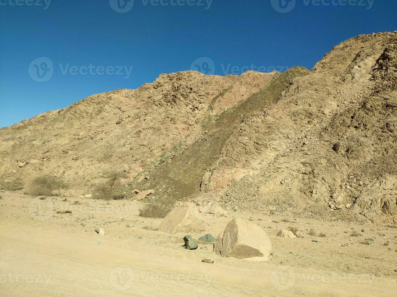 Desert land with mountains and sea photo