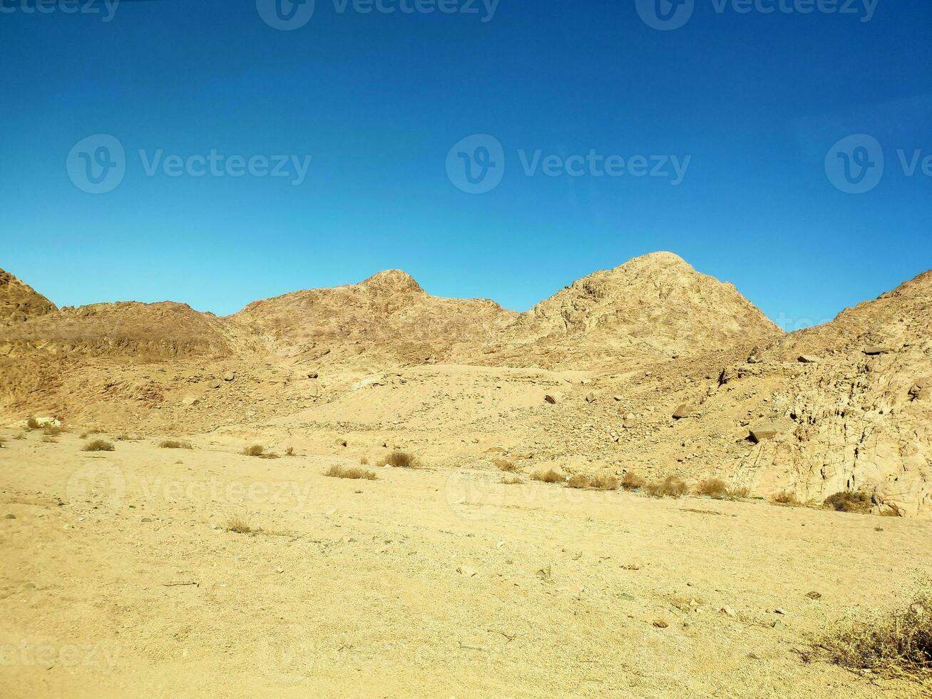 Desert land with mountains and sea photo