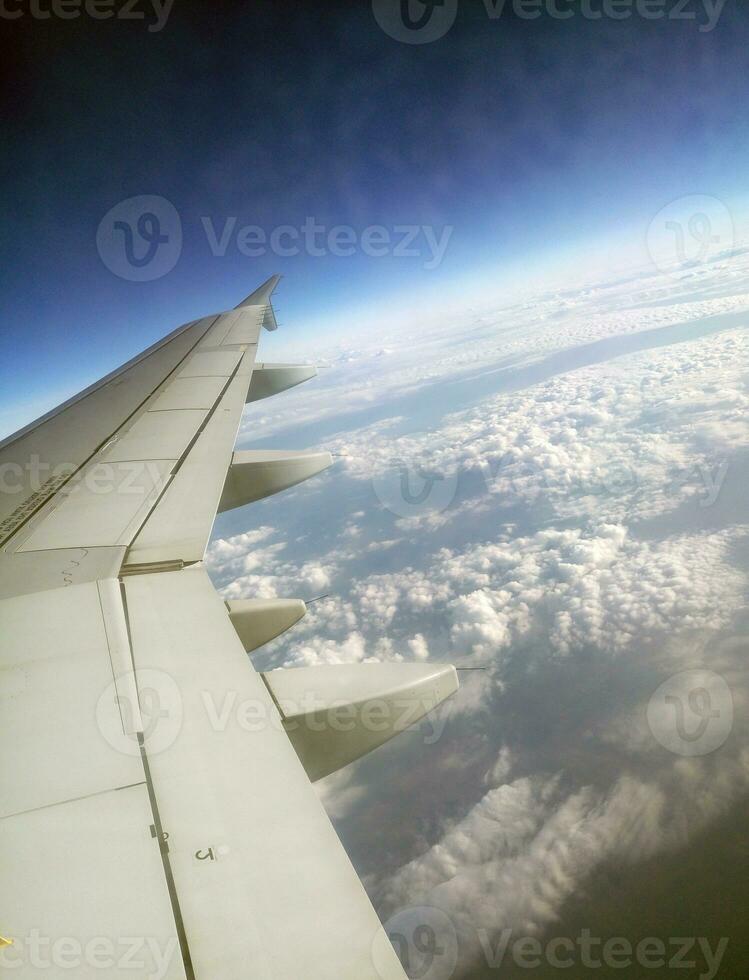 Airplane flight in deep blue sky photo