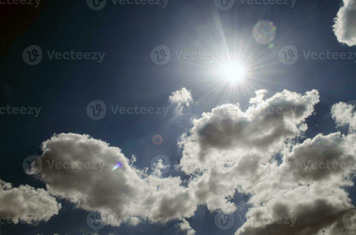 Blue sky with white clouds in sun rays photo