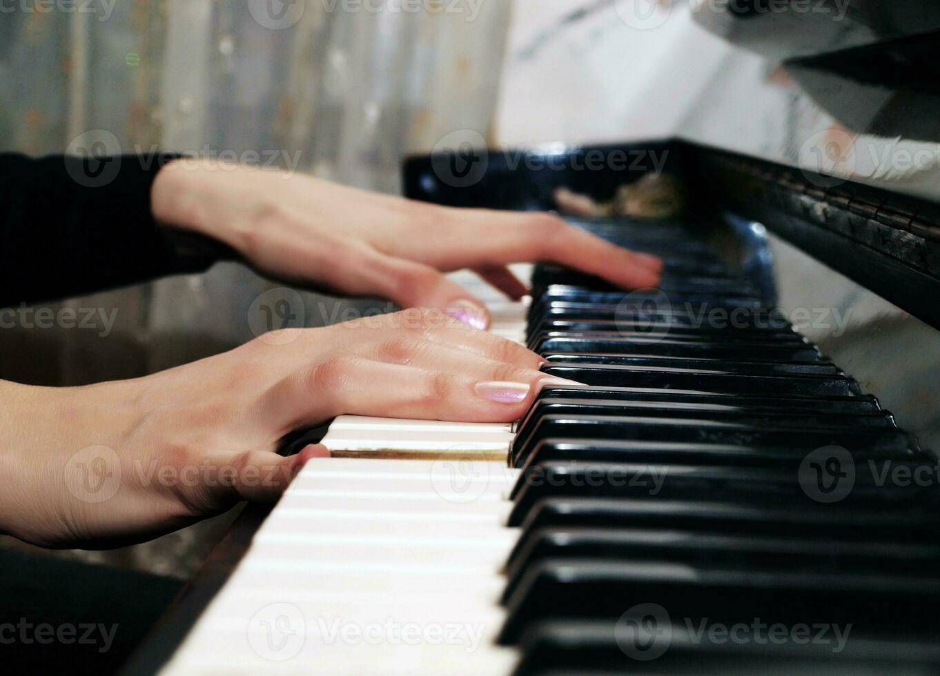 Hands playing piano photo