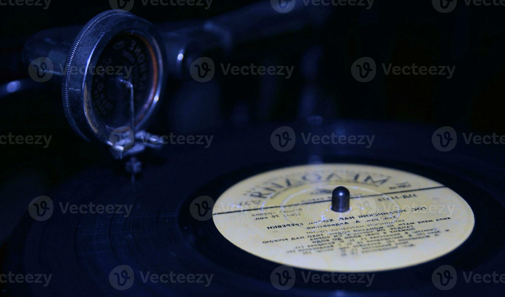 Black vinyl disc on a gramophone background photo