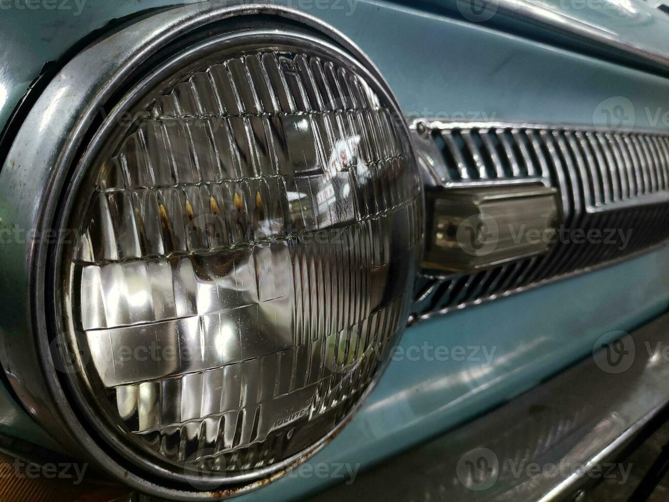 Old retro car headlight close view photo, automobile background photo