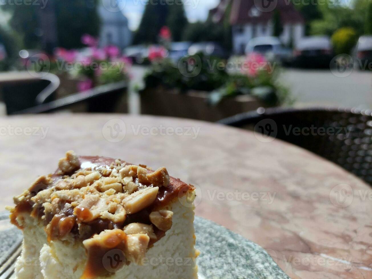 Cheese cake on a plate on a blurred city background. Gastro tour in Europe photo