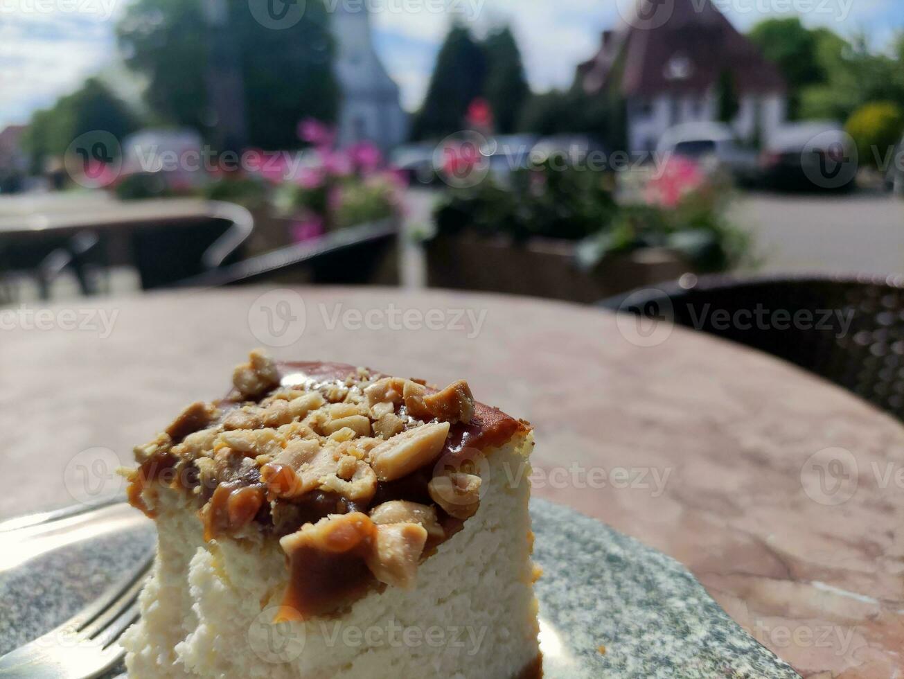 Cheese cake on a plate on a blurred city background. Gastro tour in Europe photo