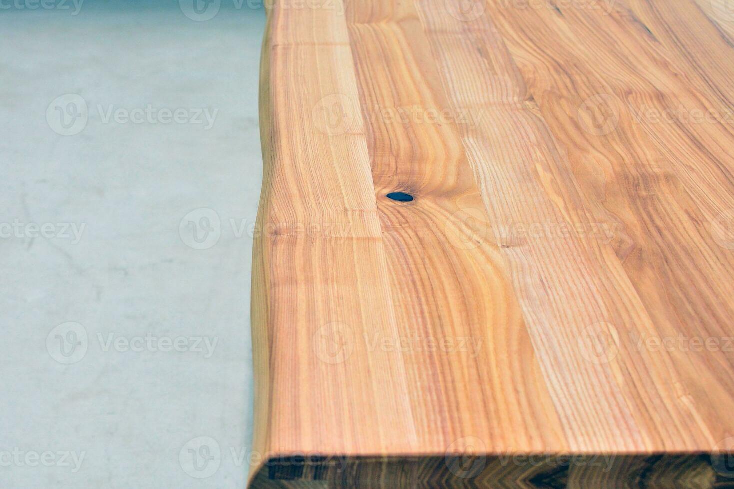 Wooden dinner table surface. Natural wood furniture close view photo