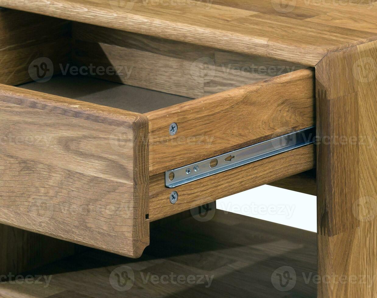 Drawer with a slider close view photo, wooden eco furniture elements background. Solid wood furniture details photo