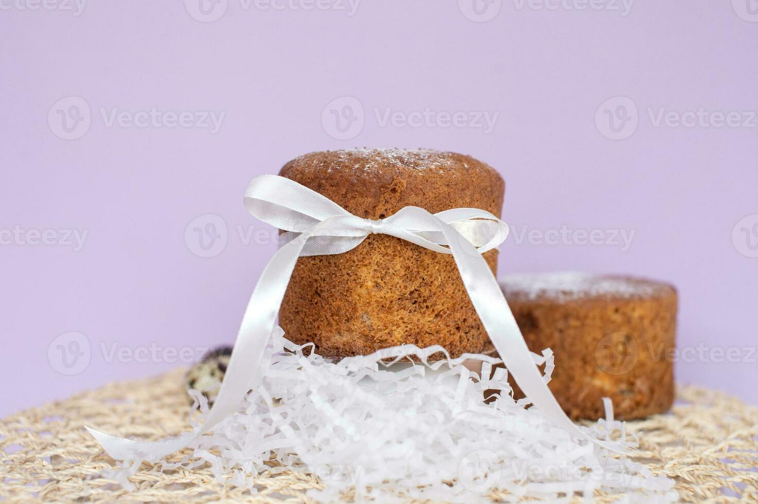 Easter pastries, sponge cake in powdered sugar with a white bow. Quail eggs. Place for text photo