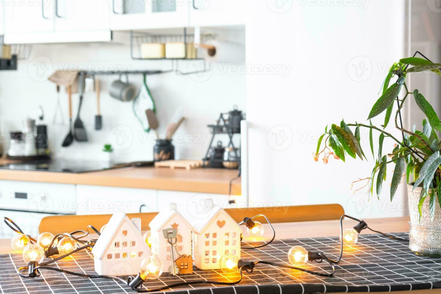 Key to house of cozy home on table of kitchen. Building, design, project, moving to new house, mortgage, insurance, rent and purchase real estate photo