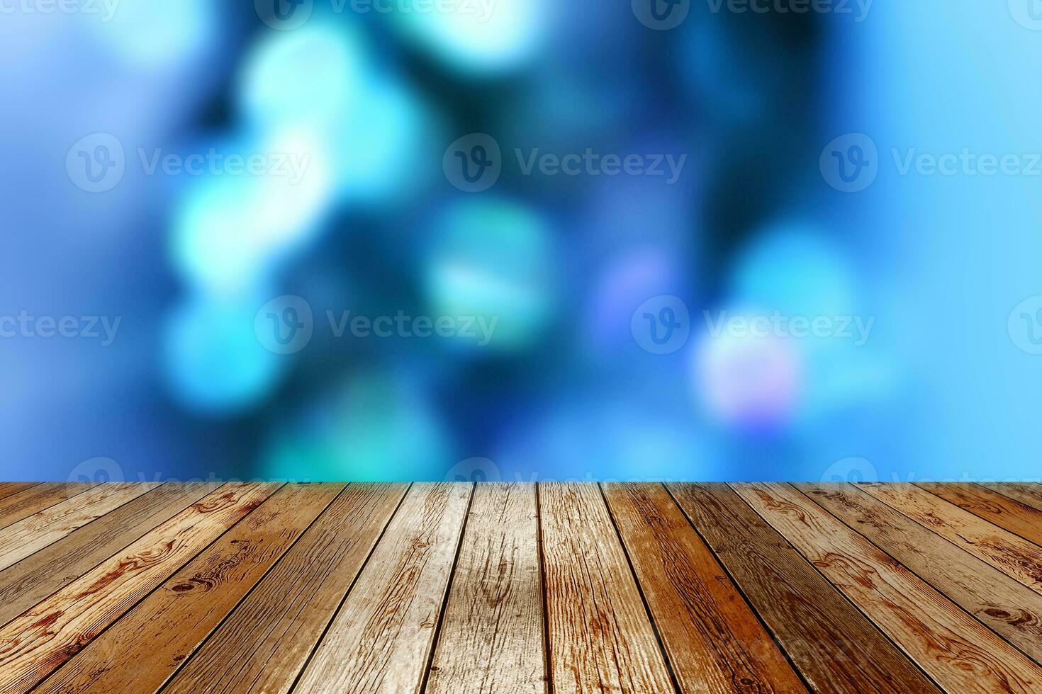 Wooden table on blue bokeh background photo