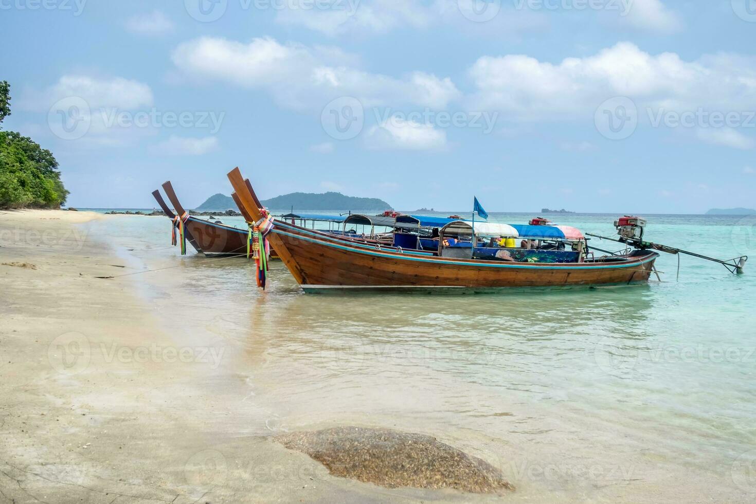 Long tail wooden boats anchored on sea in Lipe photo