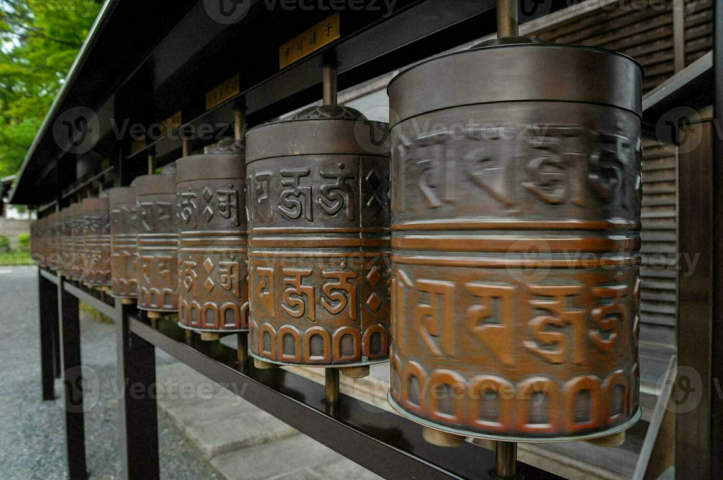 a row of prayer wheels in a buddhist temple photo