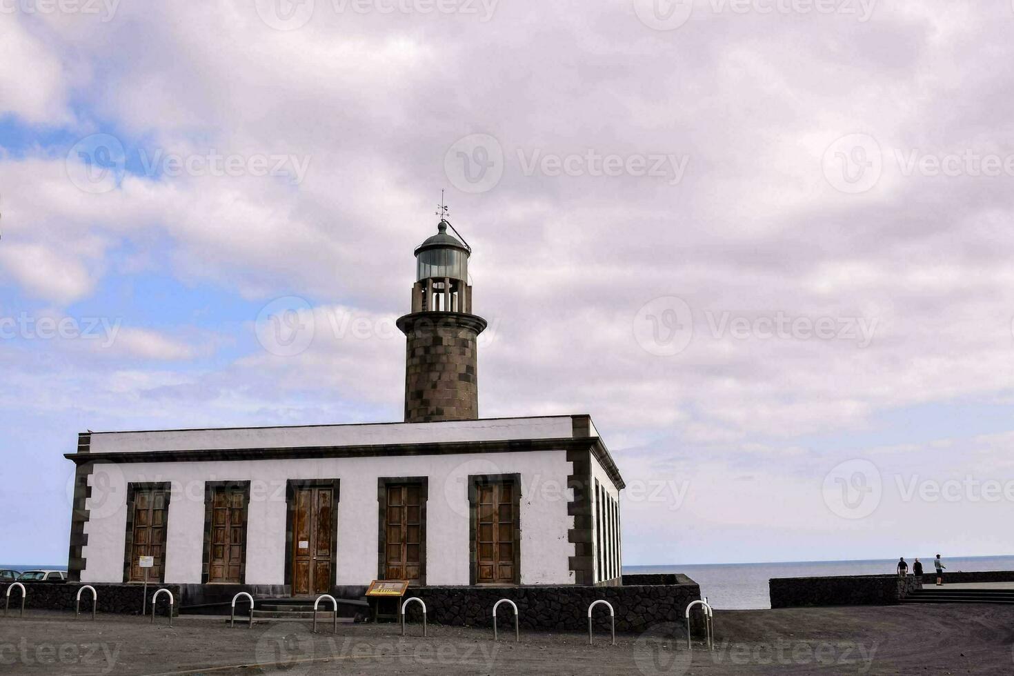 a small white building with a light on top photo