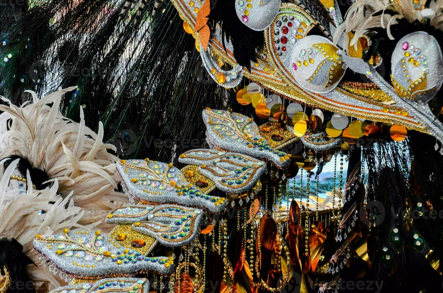 a carnival mask with feathers and gold decorations photo