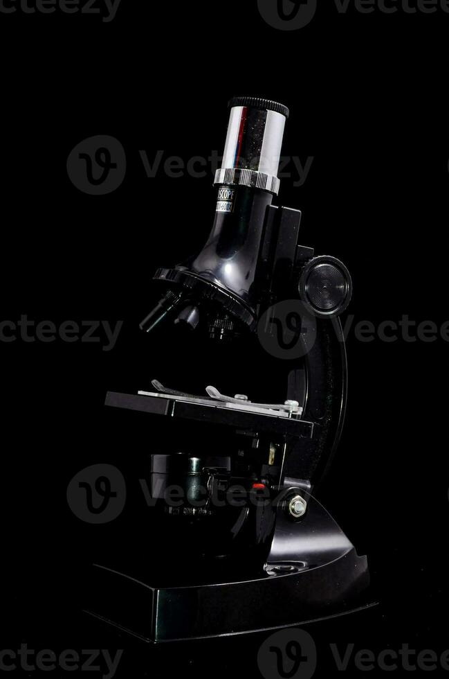 a black microscope on a black background photo