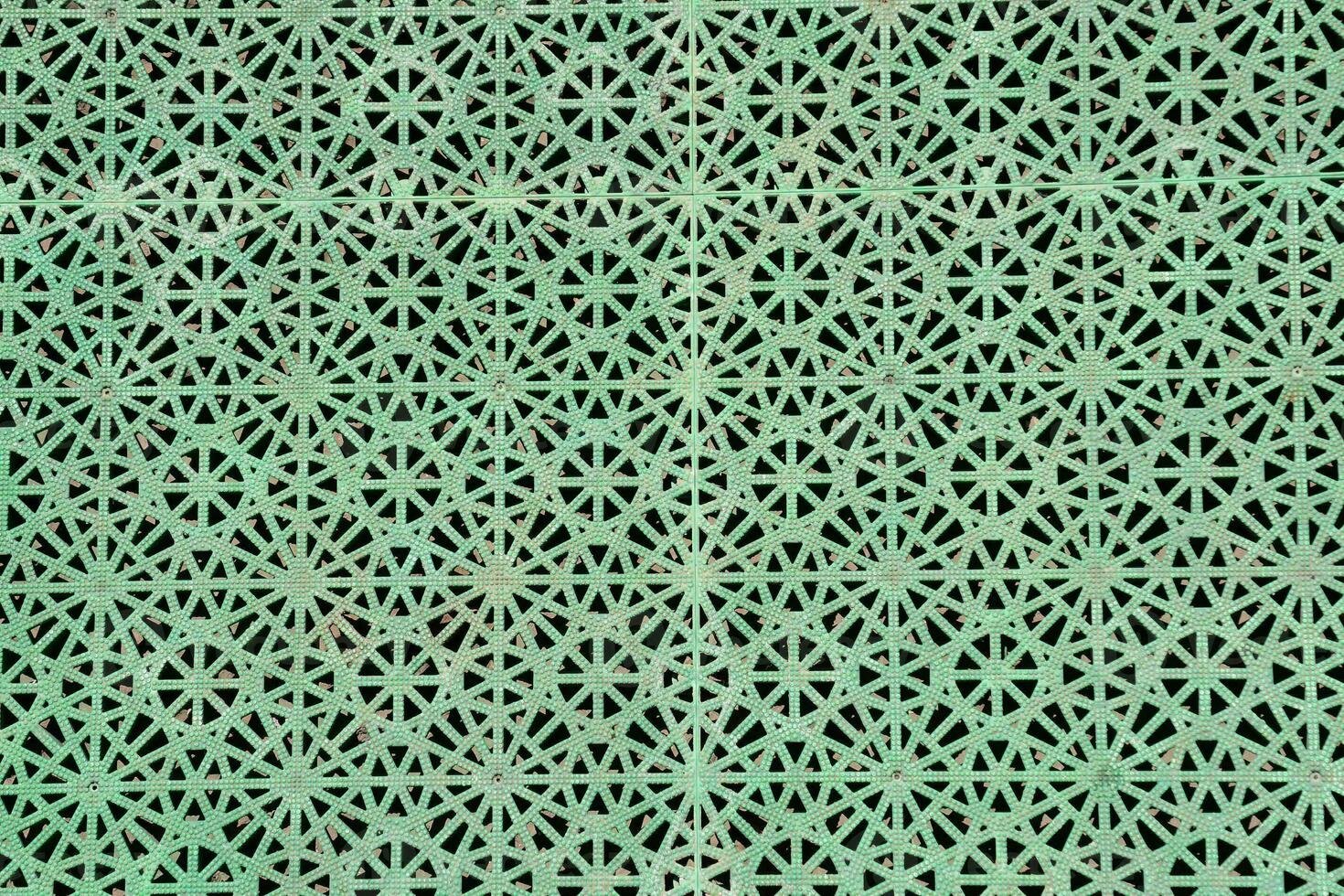 a green metal mesh with a pattern of stars photo