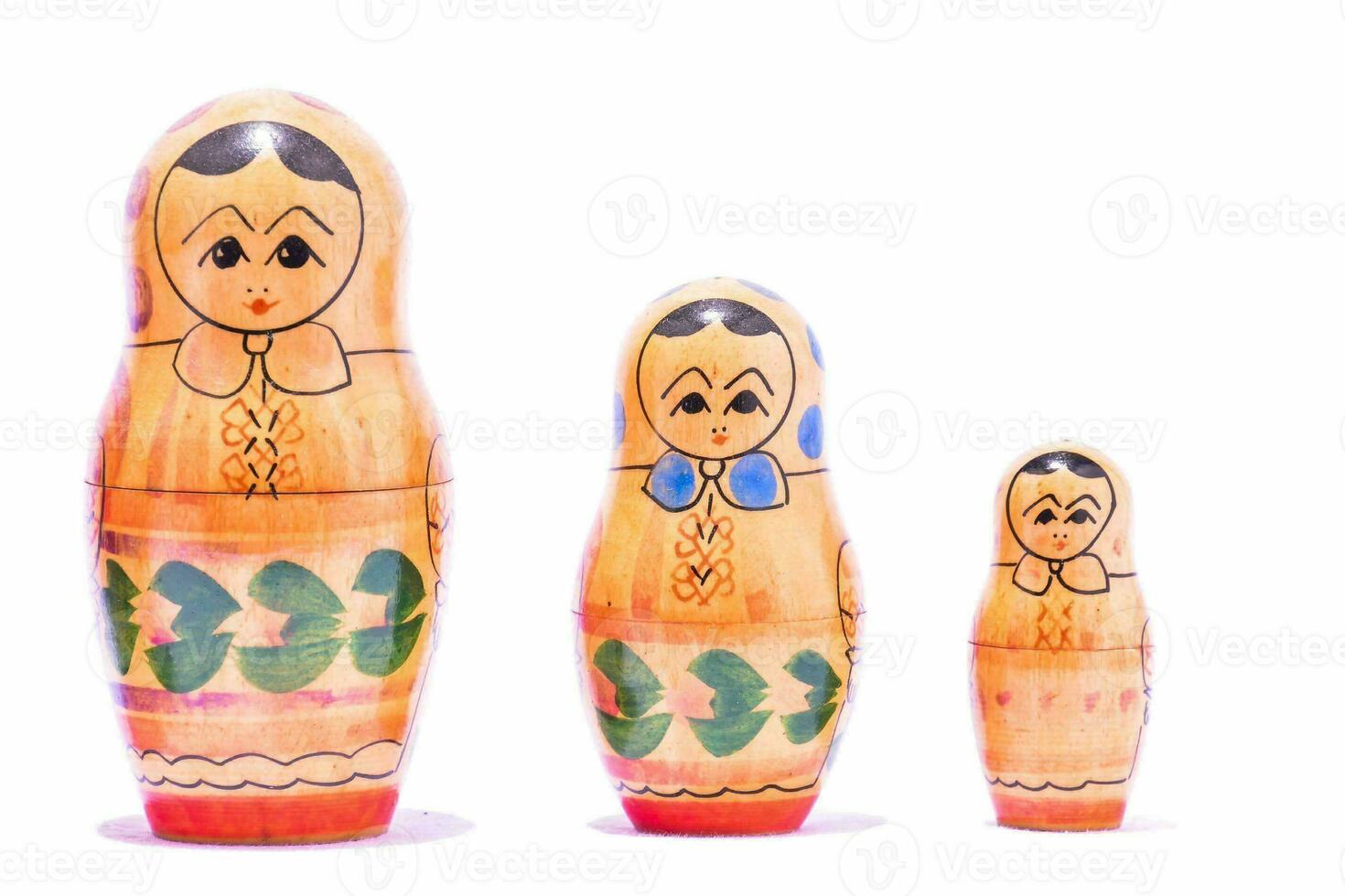 three wooden dolls with different designs photo