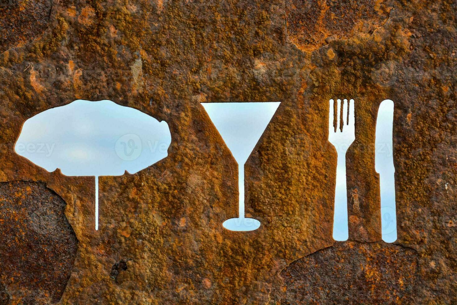 a set of cutlery shapes on a rusty wall photo