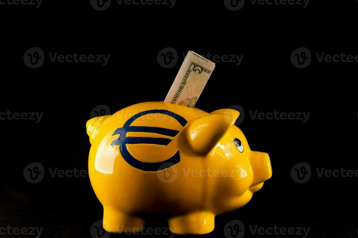 a yellow piggy bank with a euro sign and money sticking out of it photo