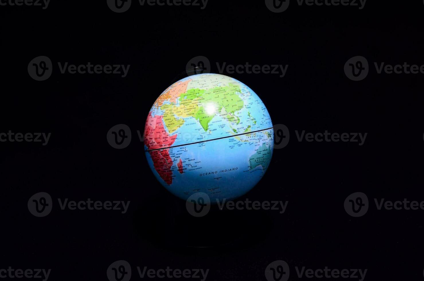 a globe on a black background with a black background photo