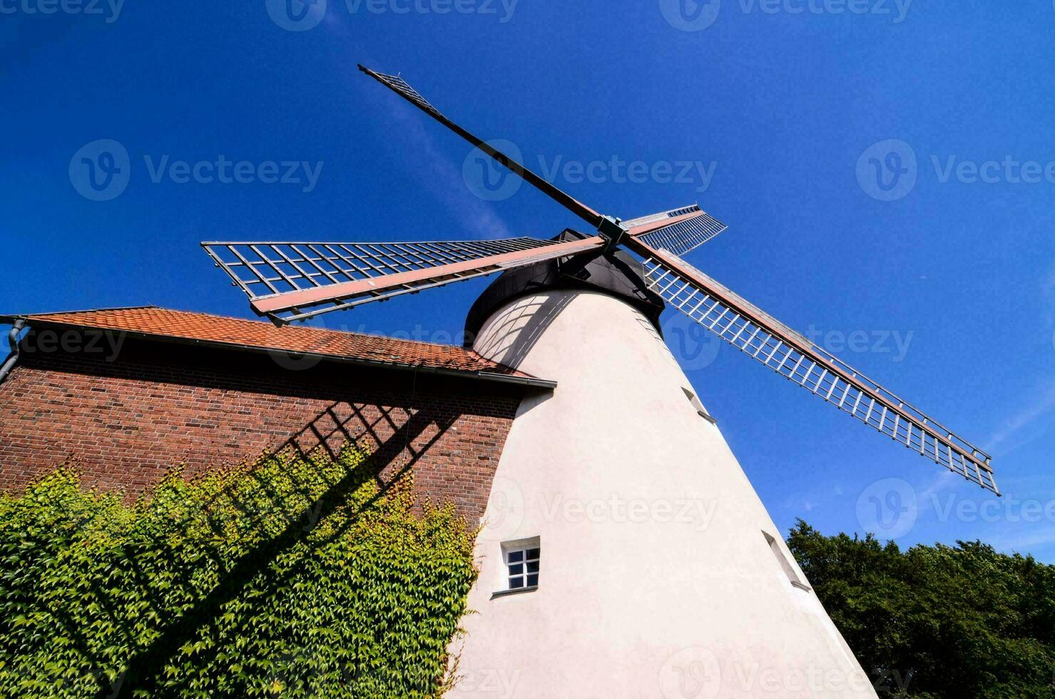 a windmill is shown against a blue sky photo