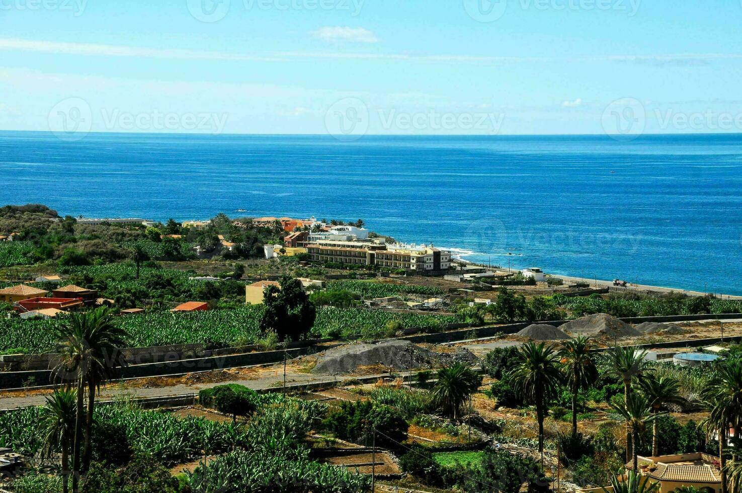 a view of the ocean and a small town on the coast photo