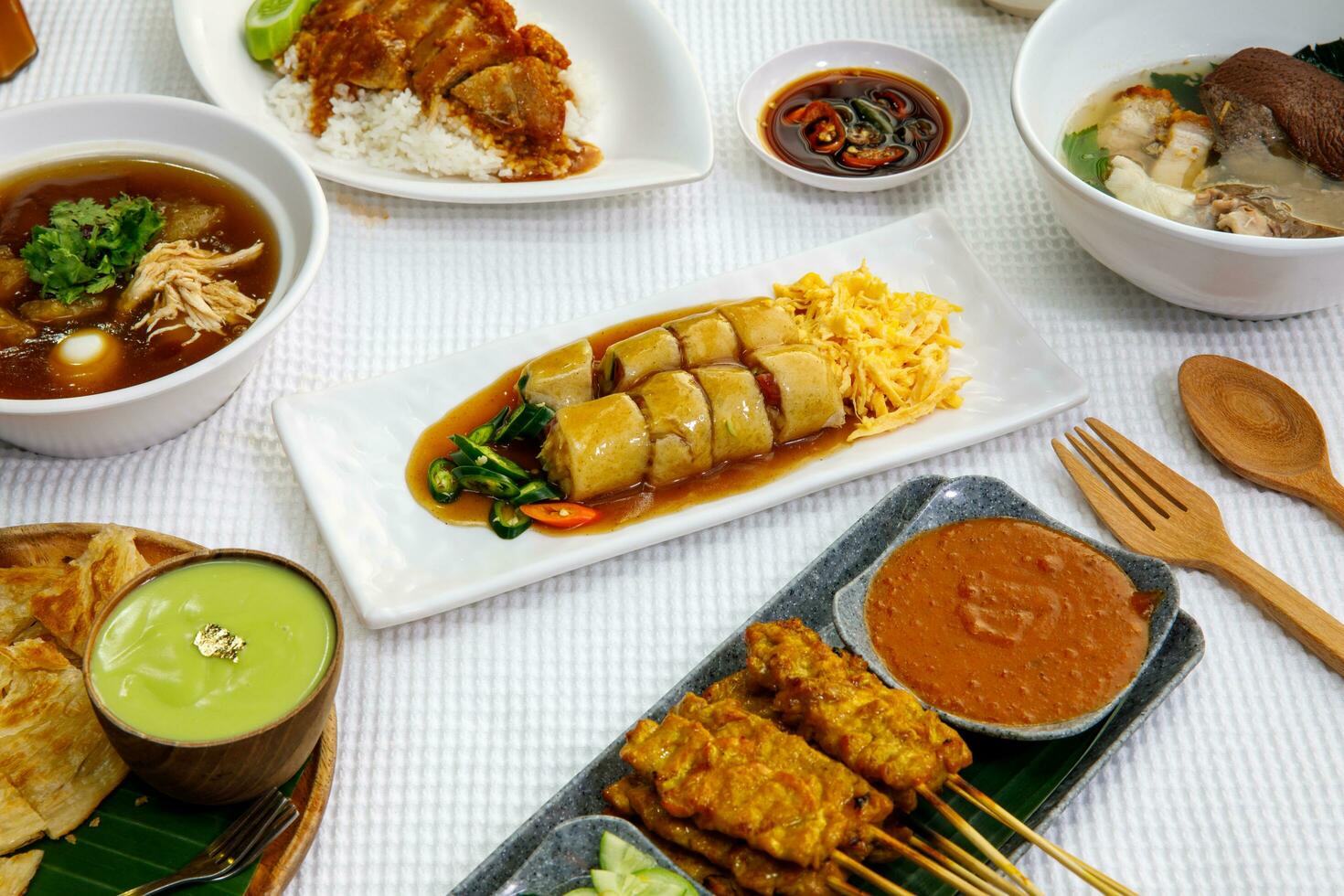 Spring rolls with tamarind sauce and spices in white disk on the brown table , concept Vietnam food in Thai photo