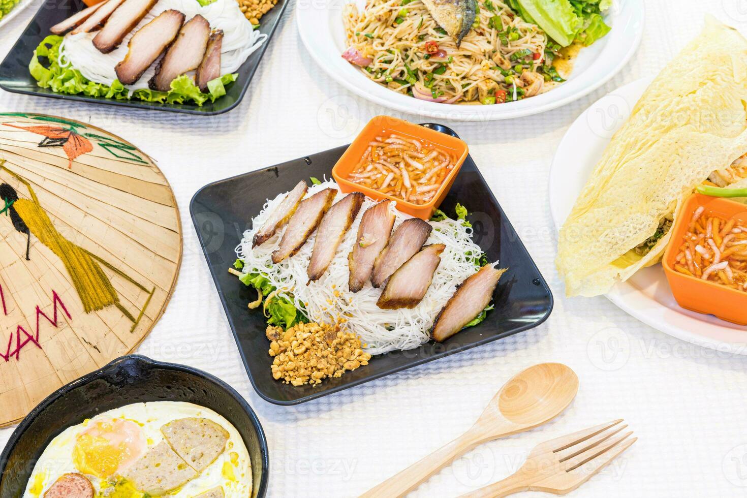 Bun thit nuong - Vietnamese grilled pork and noodles It is a mix of vermicelli noodles, grilled pork, eaten along with vegetable and sour and sweet fish sauce. - Vietnamese food photo