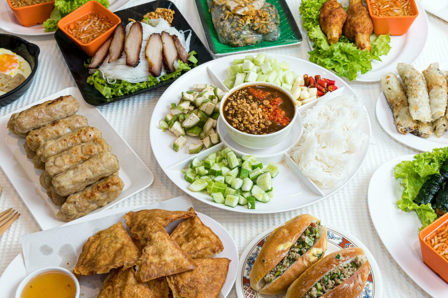 Assorted asian dinner, vietnamese food. Pho ga, pho bo, noodles, spring rolls, Nham due photo