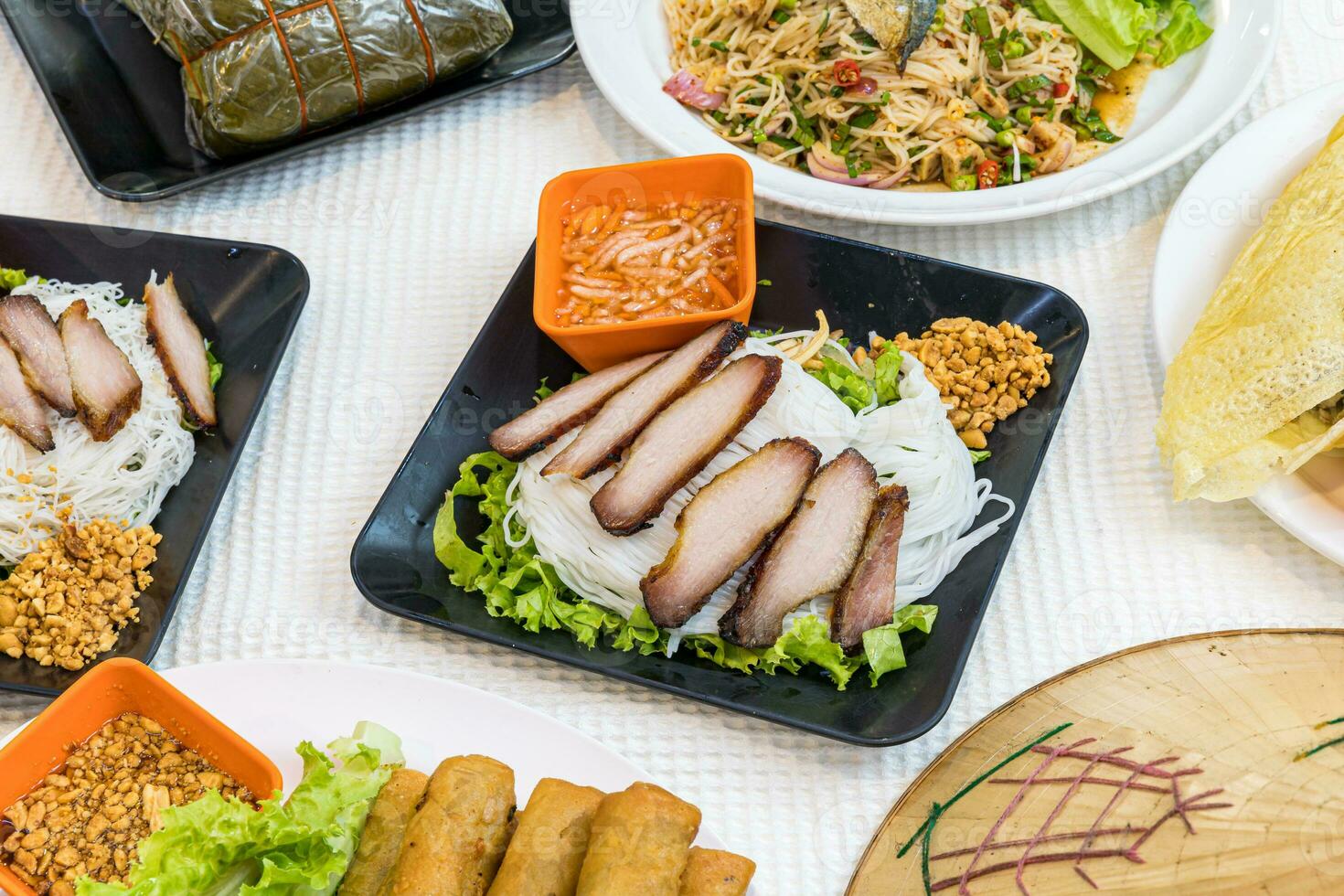 Bun thit nuong - Vietnamese grilled pork and rice noodles It is a mix of vermicelli noodles, grilled pork, eaten along with vegetable and sour and sweet fish sauce. - Vietnamese food. photo