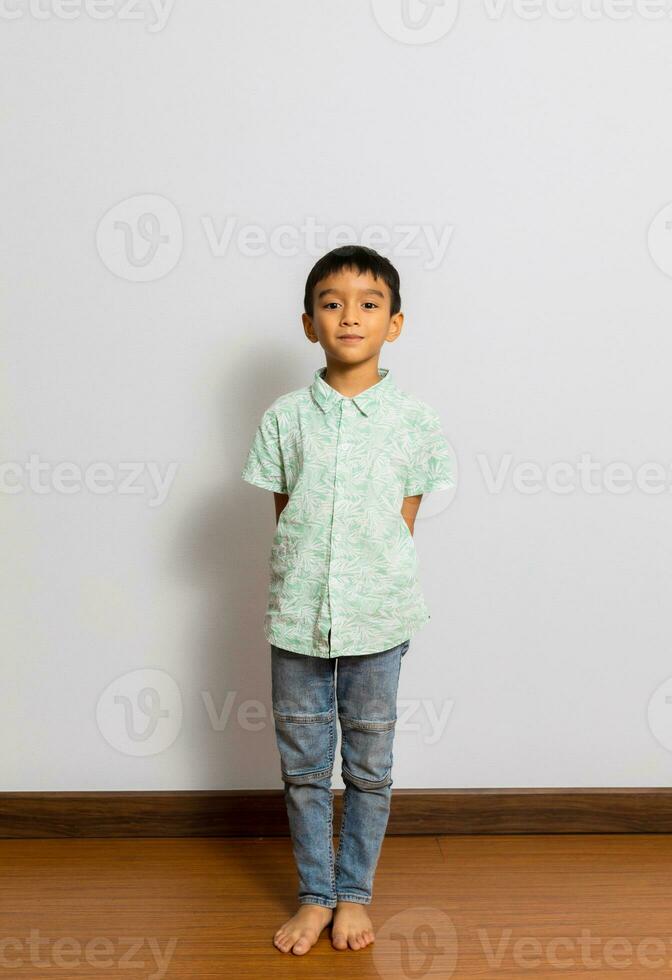 Cute little boy in casual outfit on background photo