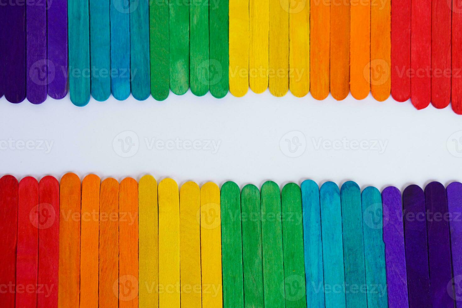 Colorful of rainbow colors made from ice cream sticks and arranged on white paper, DIY. concept. Pride month for LGBTQ community celebration in June. Human right equality. photo