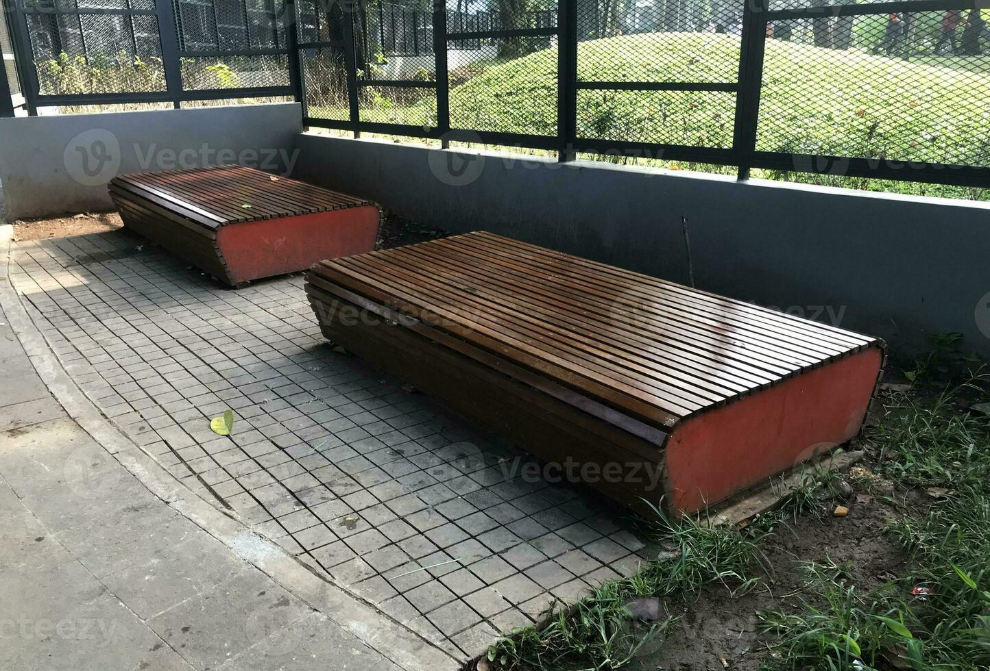 Jakarta, Indonesia, 2023 - Portrait of a pair of empty park benches at Tebet Eco Park, Jakarta. photo