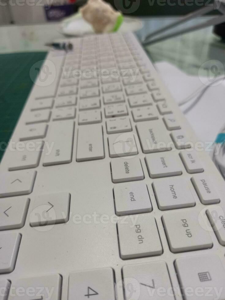 white keyboard with thai letters English keys are soft to the touch. photo