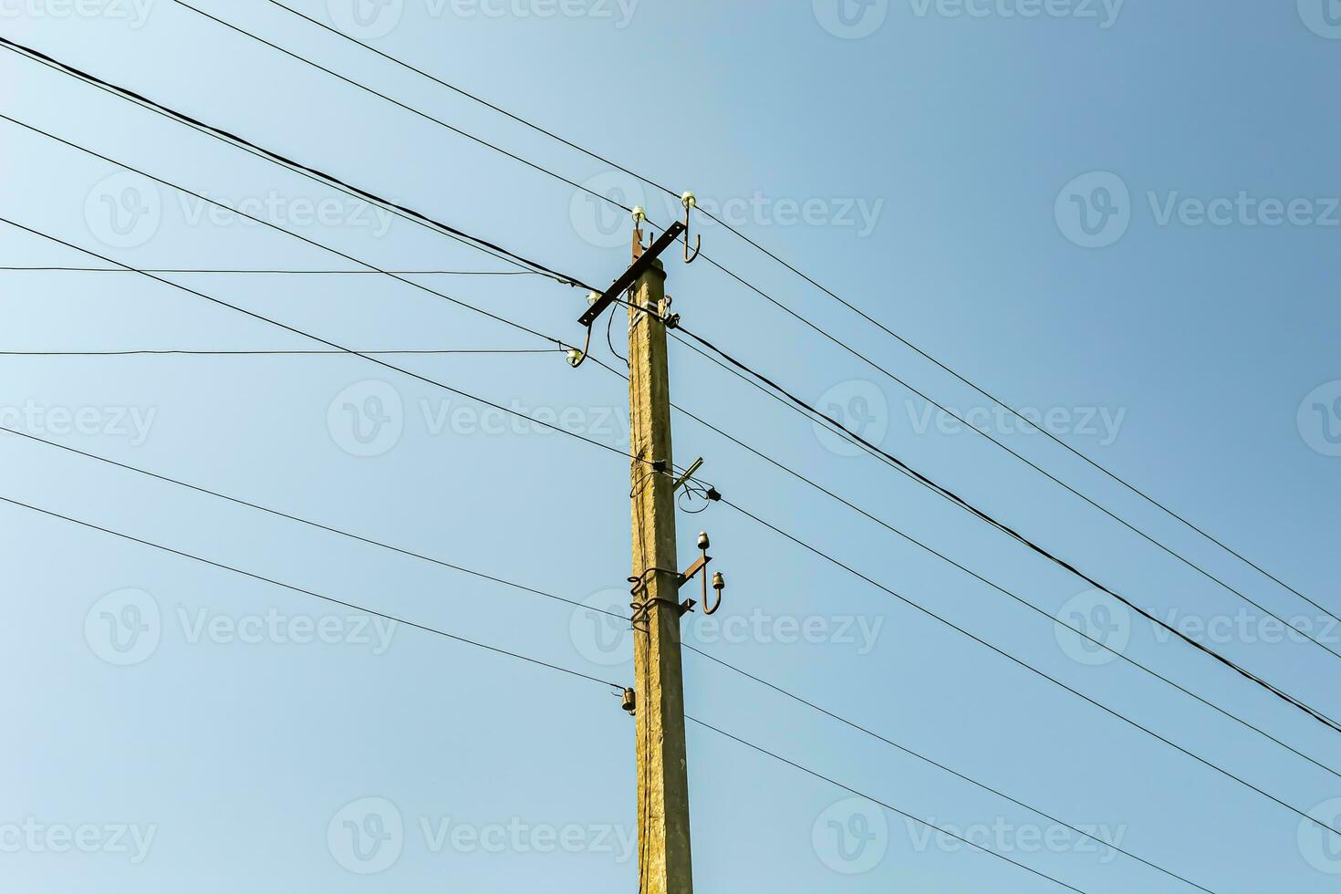 Power electric pole with line wire on colored background close up photo