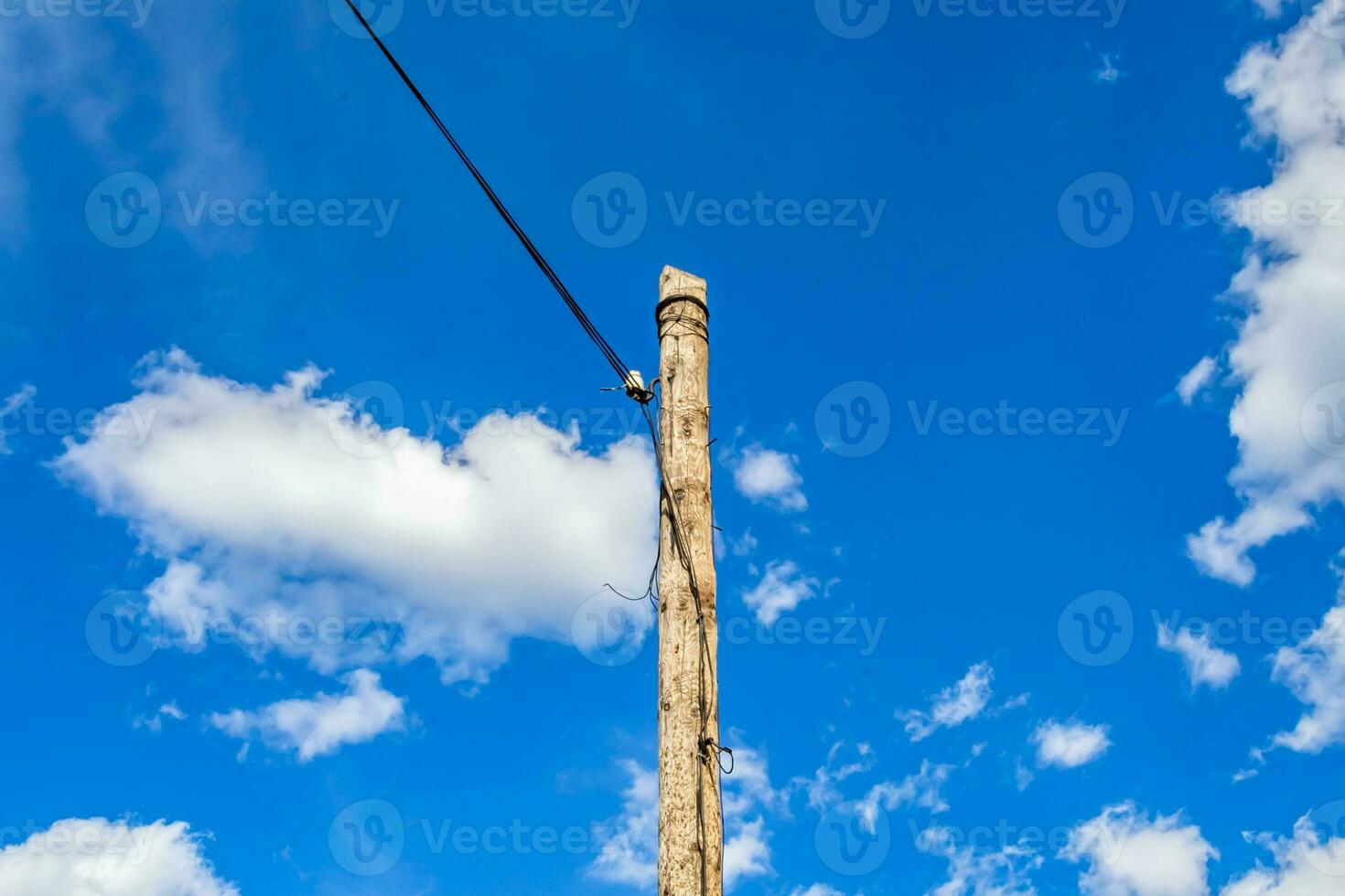 Power electric pole with line wire on colored background close up photo