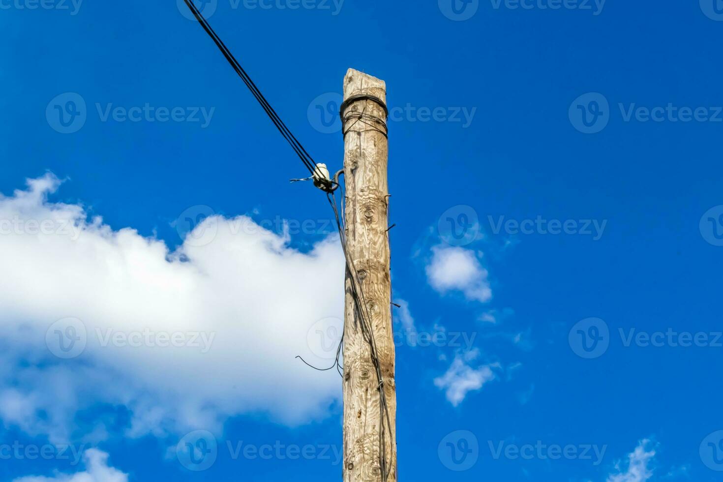 Power electric pole with line wire on colored background close up photo