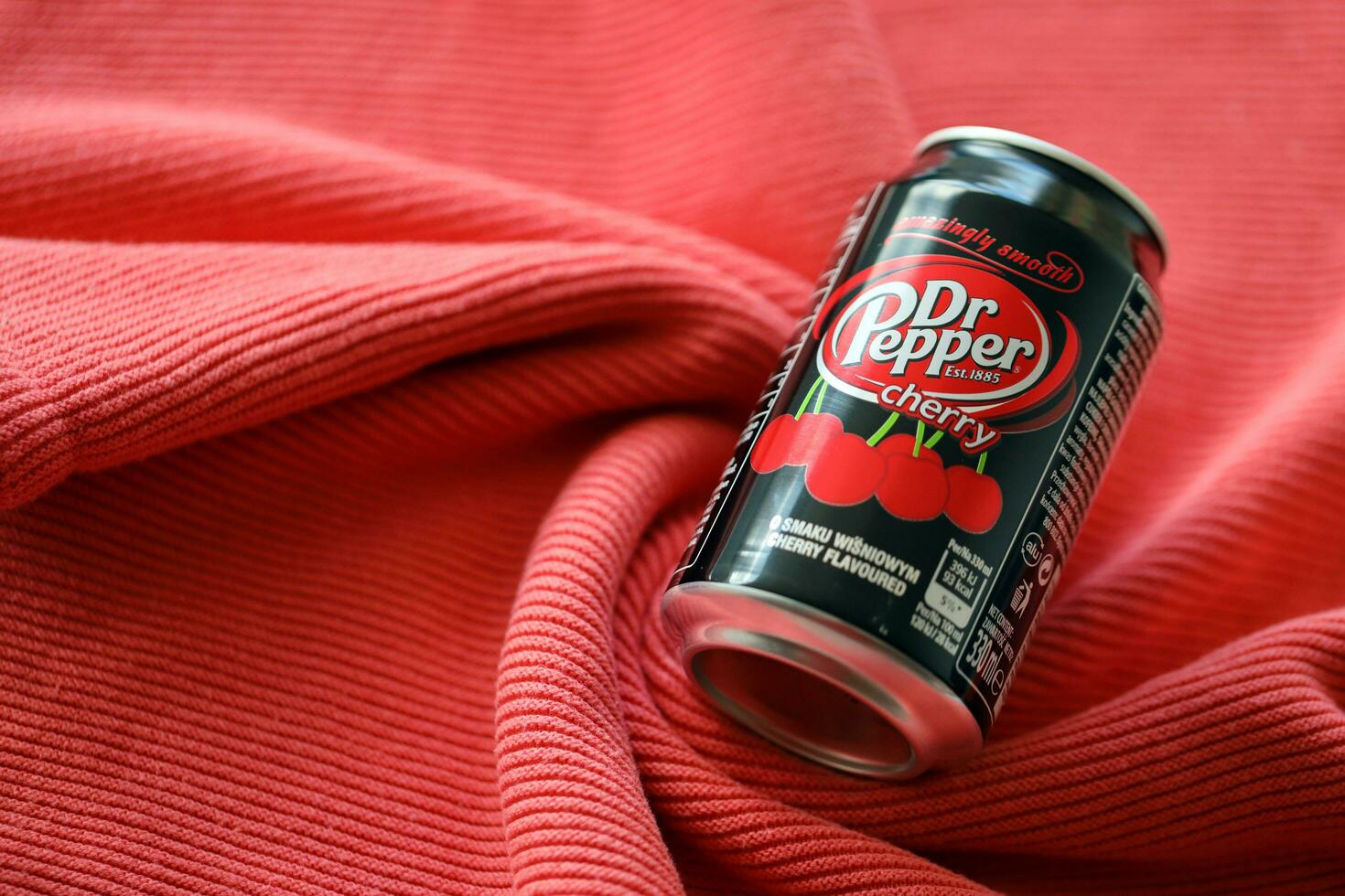 KYIV, UKRAINE - JULY 7, 2023 Dr Pepper cherry drink can on red background photo