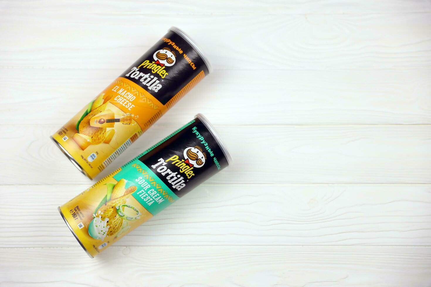 Pringles cylinder tubes with Tortilla el nacho cheese and sour cream fiesta flavour. Pringles is a brand of potato snack chips owned by Kellogg Company photo