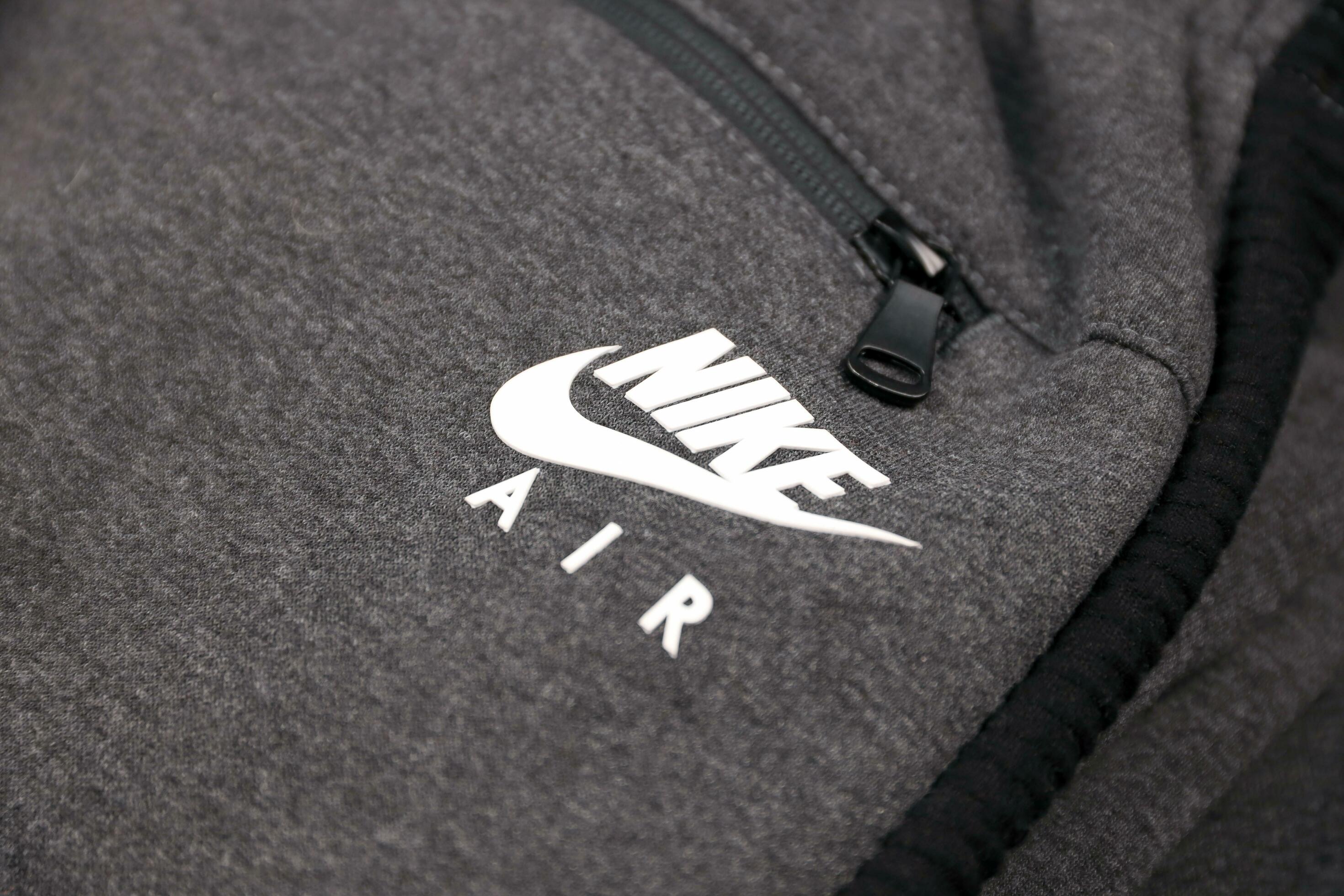 KHARKOV, UKRAINE - DECEMBER 20, 2020 Nike air logo on grey sports wear  fragment. Nike is American multinational corporation engaged in  manufacturing and worldwide marketing of clothes and footwear 31232502  Stock Photo at Vecteezy