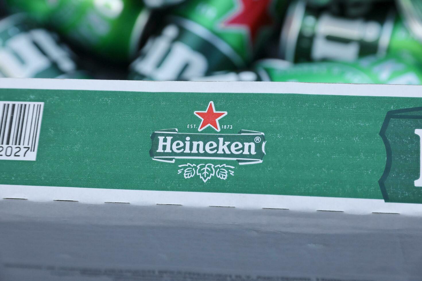 KHARKOV, UKRAINE - JULY 31, 2021 Green tin cans of Heineken lager beer produced by the Dutch brewing company Heineken N.V. photo