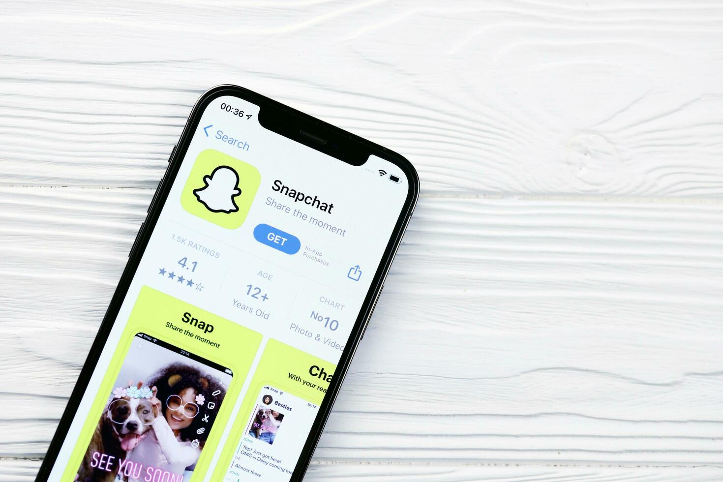 KHARKOV, UKRAINE - MARCH 5, 2021 Snapchat icon and application from App store on iPhone 12 pro display screen on white table photo