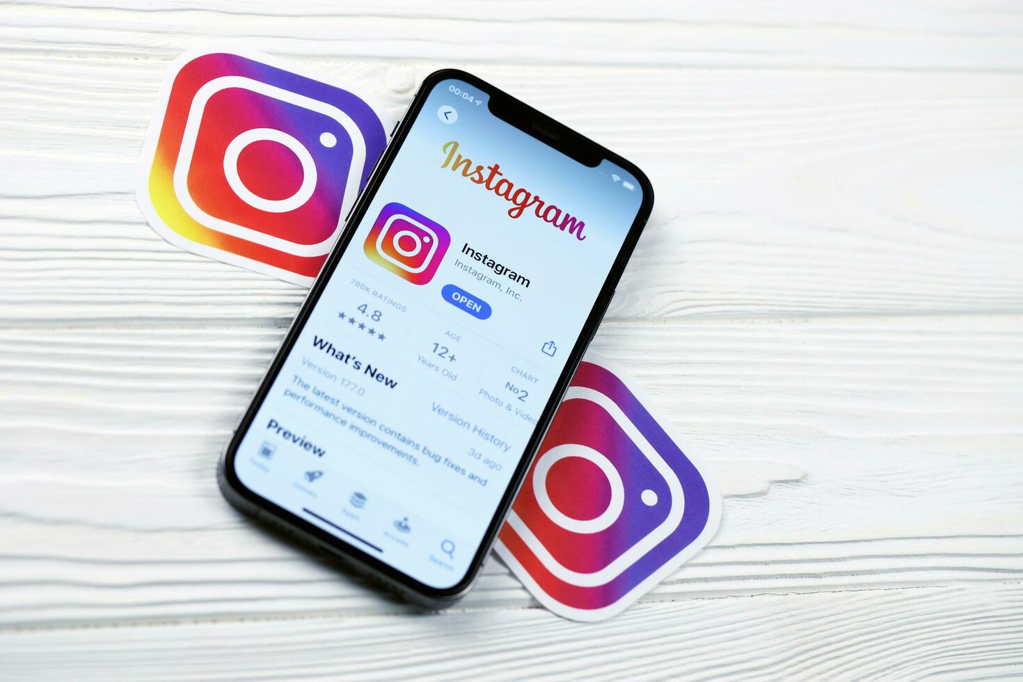 KHARKOV, UKRAINE - MARCH 5, 2021 Instagram icon and application from App store on iPhone 12 pro display screen on white table photo