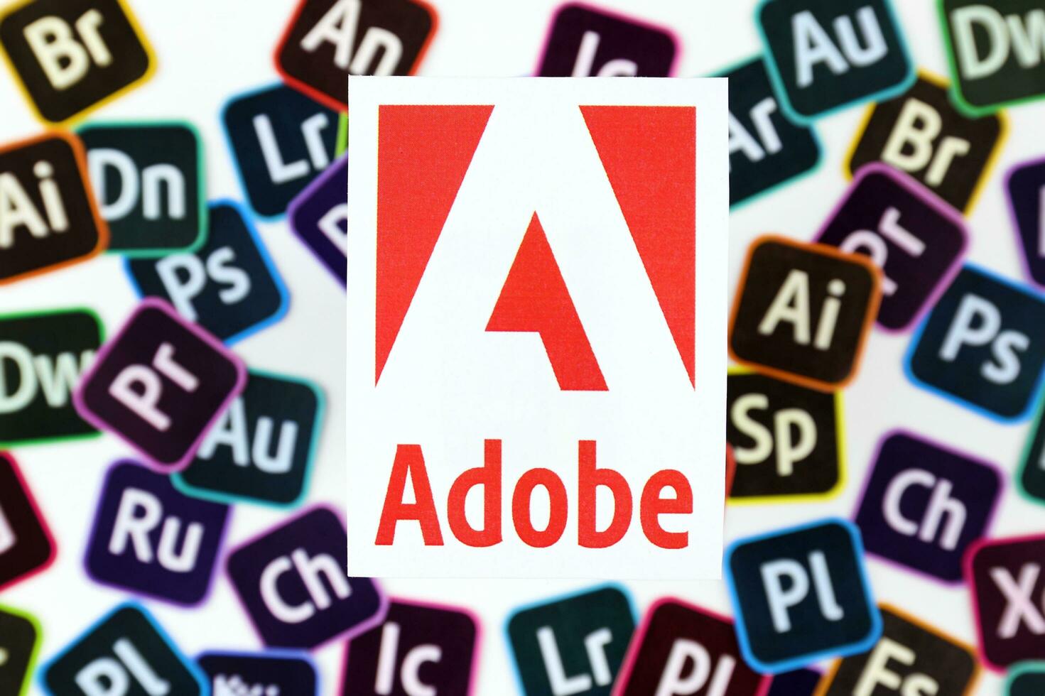 KHARKOV, UKRAINE - DECEMBER 26, 2020 Paper logos of most popular adobe products on white background. Photoshop illustrator bridge indesign premierepro aftereffects lightroom flashbuilder etc photo