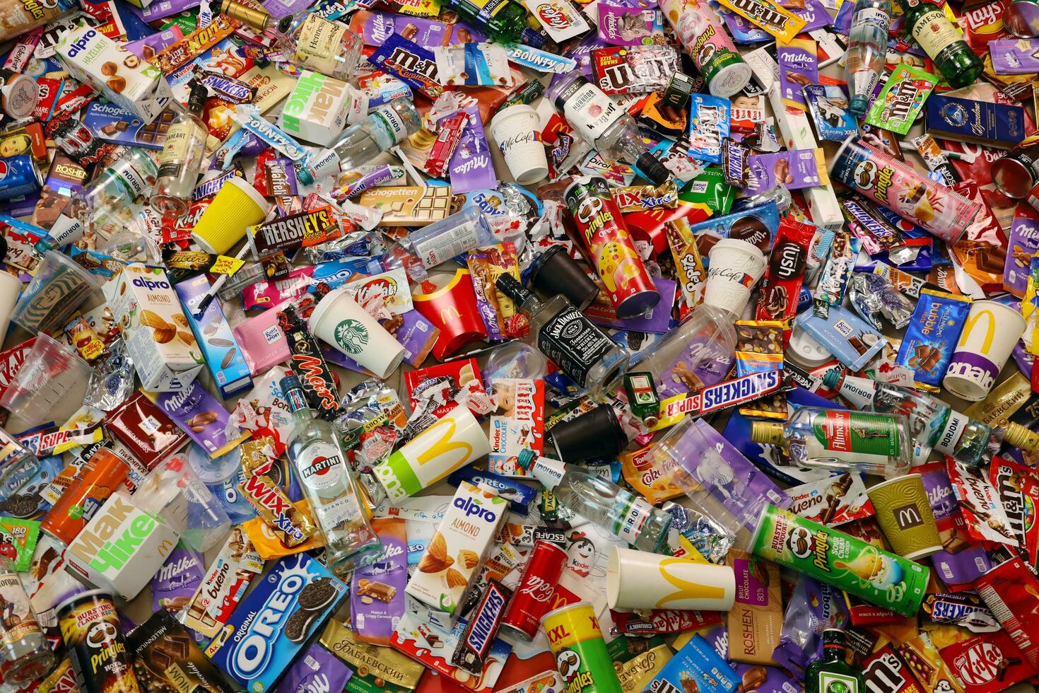 KHARKOV, UKRAINE - AUGUST 10, 2021 Big pile of various wrappings and empty disposable packages and cups from famous branded food production photo