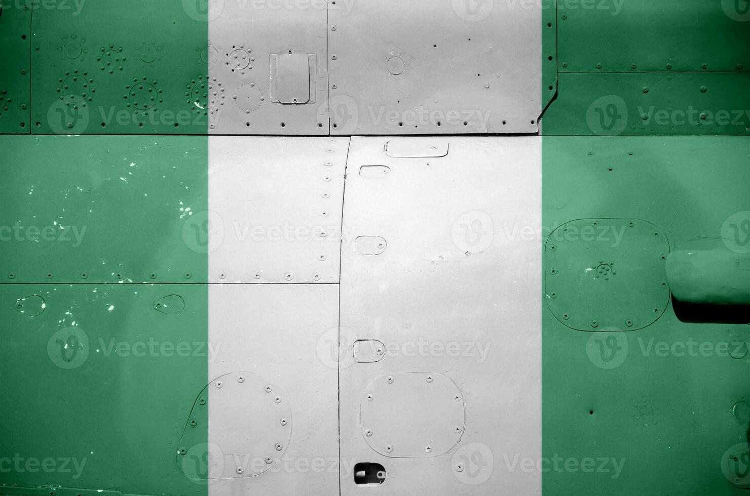 Nigeria flag depicted on side part of military armored helicopter closeup. Army forces aircraft conceptual background photo