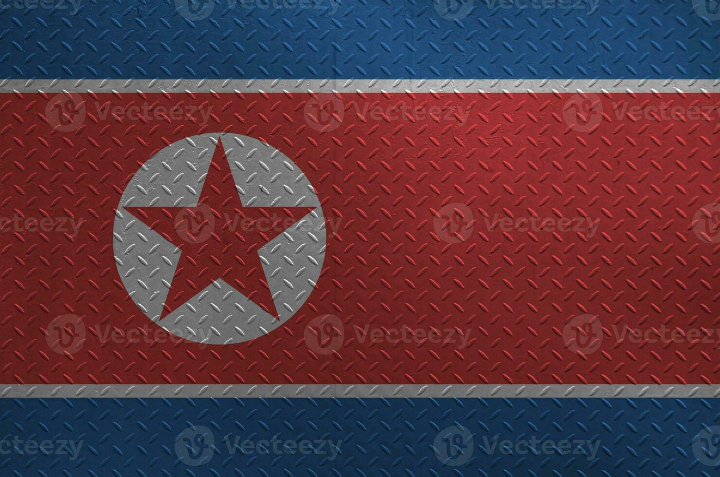 North Korea flag depicted in paint colors on old brushed metal plate or wall closeup. Textured banner on rough background photo