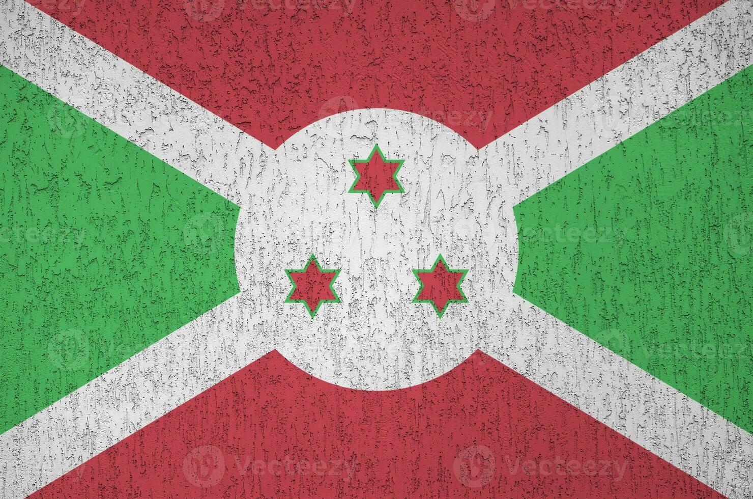 Burundi flag depicted in bright paint colors on old relief plastering wall. Textured banner on rough background photo